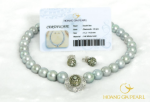 Close-up view of the Drum Pearl jewelry design by Hoang Gia Pearl, showcasing engraved motifs inspired by the Dong Son bronze drum, South Sea pearls, and diamond-set white gold details.